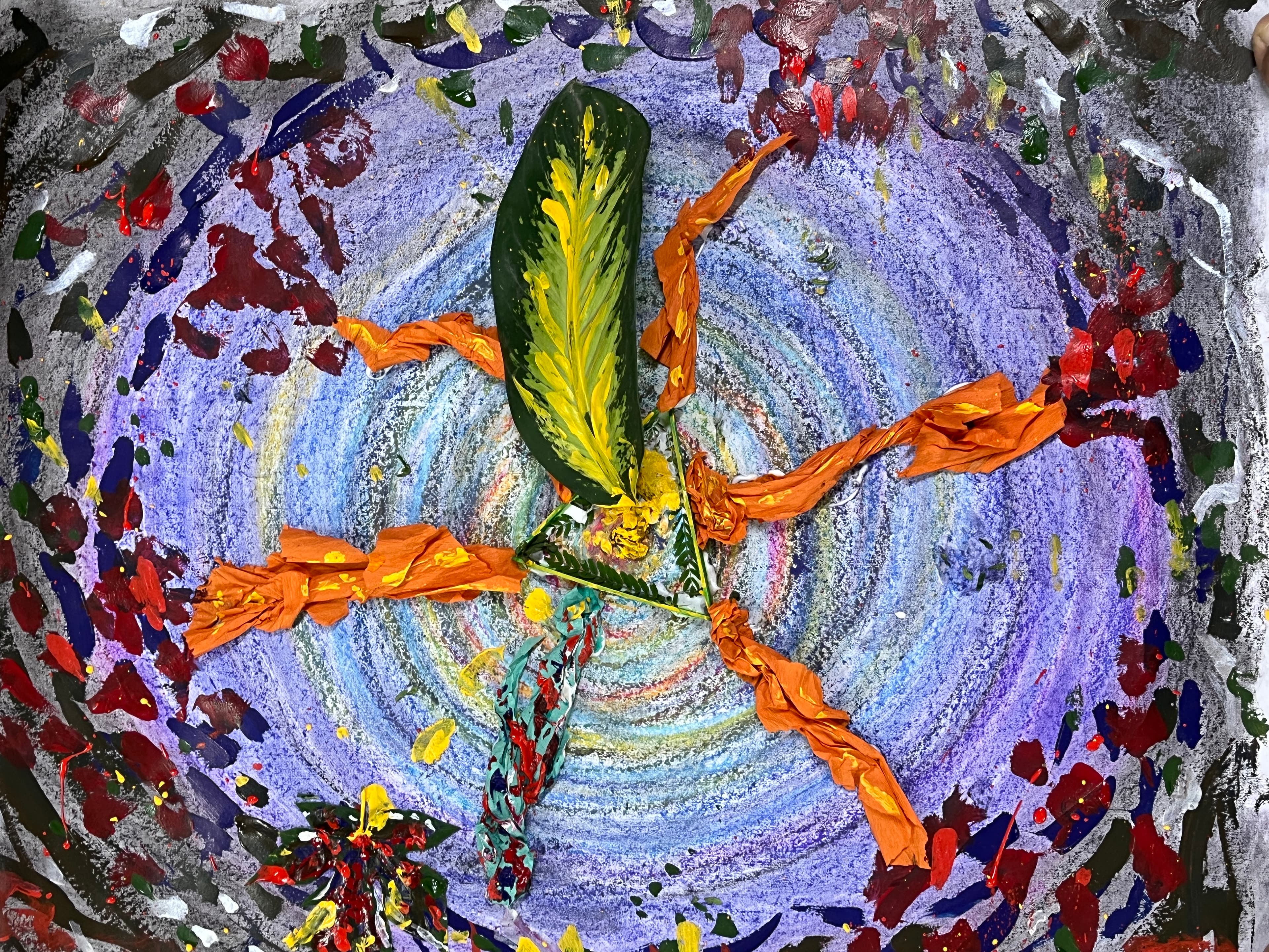 A collaborative artwork of swirling purple and blue pastel with orange crepe paper, painted leaves and splashes of red, green and yellow paint