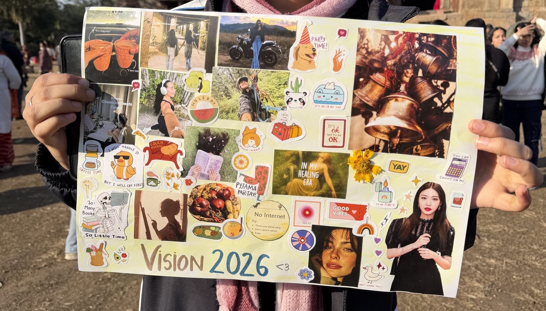 A festival participant holding up a hand-made 'Vision 2026' collage at Lodhi Garden